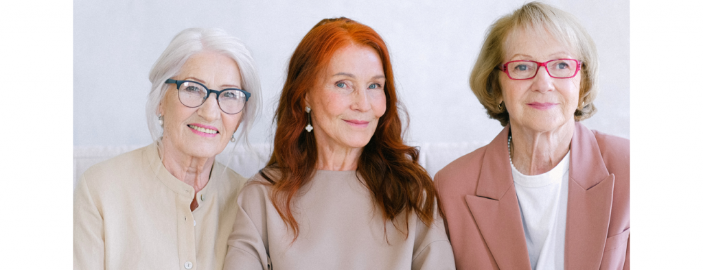 A group of three older women smiling together